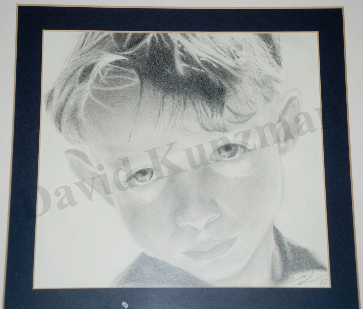 A portrait of a boy drawn using pencils.