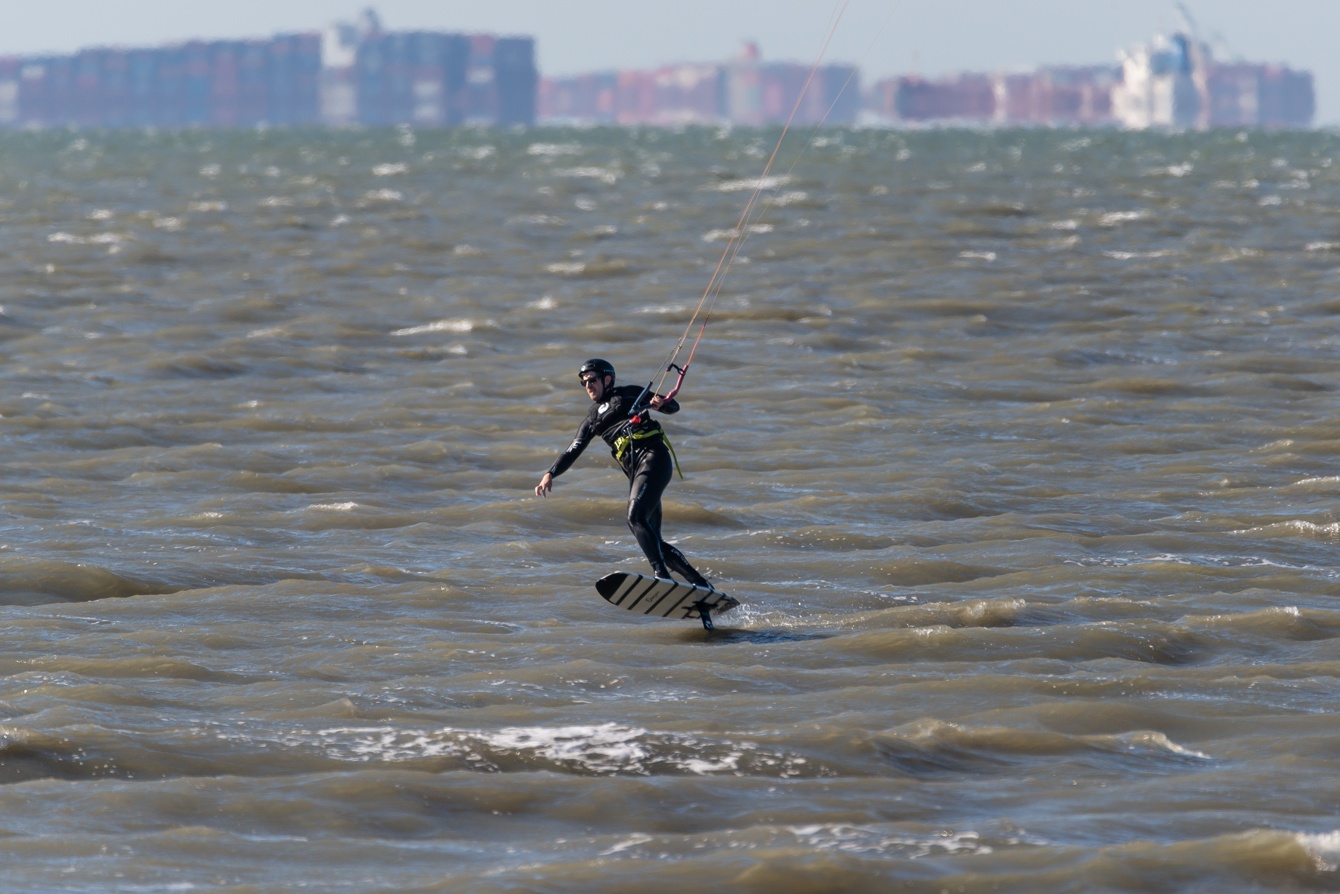 Photographs of people doing various watersports (kite surfing, kite boarding, wind surfing, etc.) at Coyote Point in San Mateo, California (Bay Area) on a clear, beautiful day.